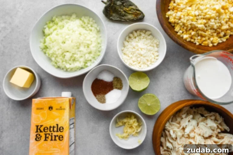 Creamy Elote Chowder 4 A collection of fresh ingredients arranged in small bowls, including minced onions, vibrant corn kernels, a mix of spices, zesty lime, cooked chicken, and rich chicken broth, all ready for making Mexican Street Corn Soup.