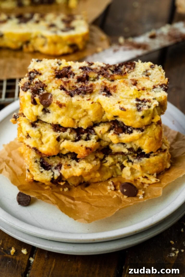 Bright Orange Chocolate Chip Scone Bread 3 A stack of three generously sized slices of chocolate orange scone bread, showcasing its rich, moist texture and abundant chocolate chips.