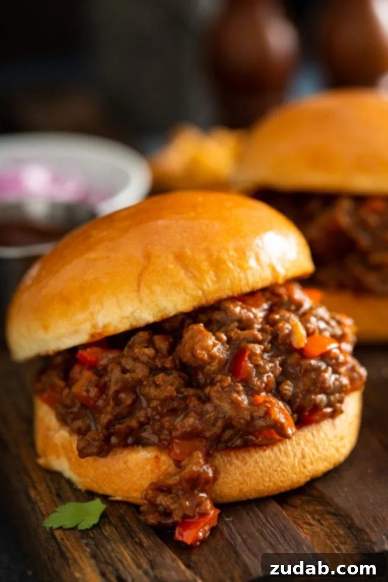 Weekly Meal Plan February 12 to 18 3 A close-up of a delicious Instant Pot Sloppy Joe on a perfectly toasted bun, garnished with fresh red bell peppers and a rich, thick sauce, ready for a quick and satisfying weeknight dinner.