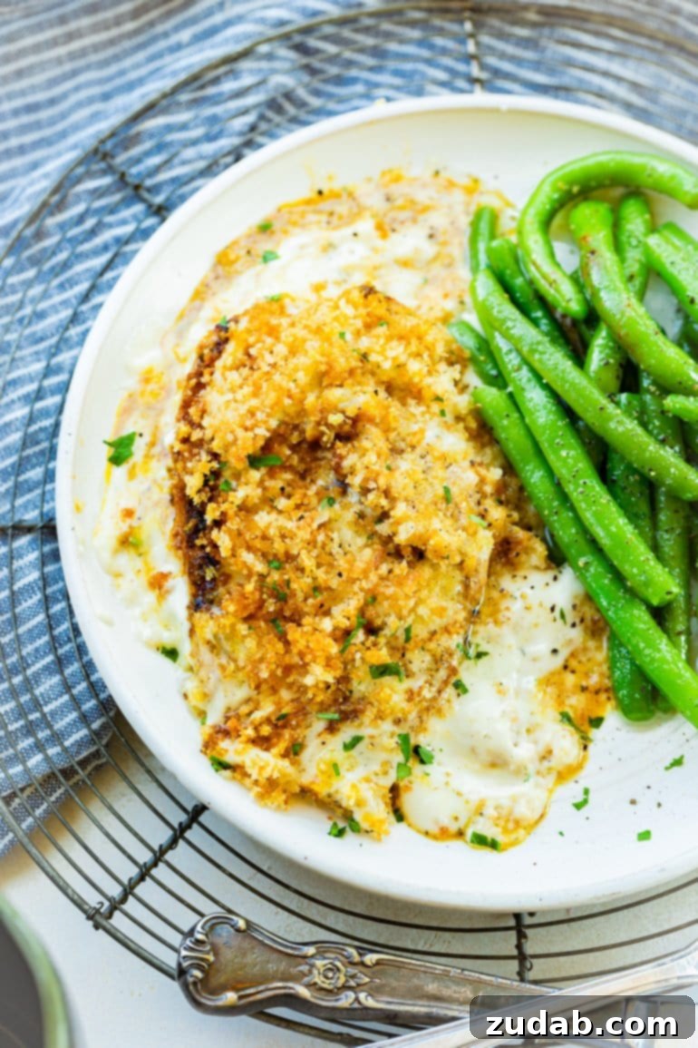 Weekly Meal Plan February 12 to 18 6 A succulent Panko-crusted Ranch Baked Chicken breast, perfectly golden and tender, nestled in a creamy sauce, accompanied by a serving of fresh green beans, offering a delightful and easy weeknight meal.