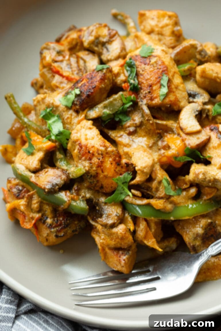Easy One-Pan Creamy Chicken 8 A beautifully presented serving of Pollo a la Crema on a dinner plate, generously topped with freshly chopped cilantro, ready for a delicious meal.