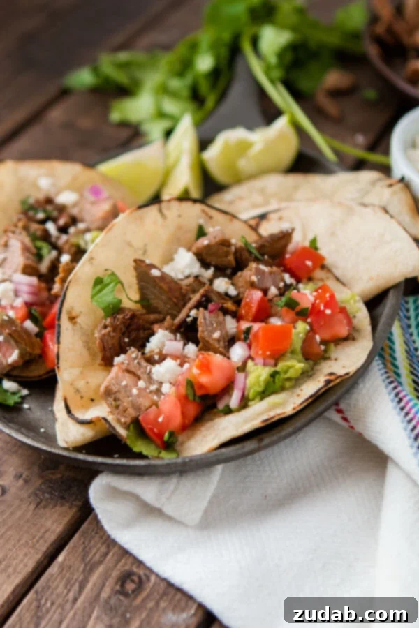 Weekly Menu Plan: Mar. 11-17 7 Two authentic carne asada tacos on a serving plate on top of a wooden table.