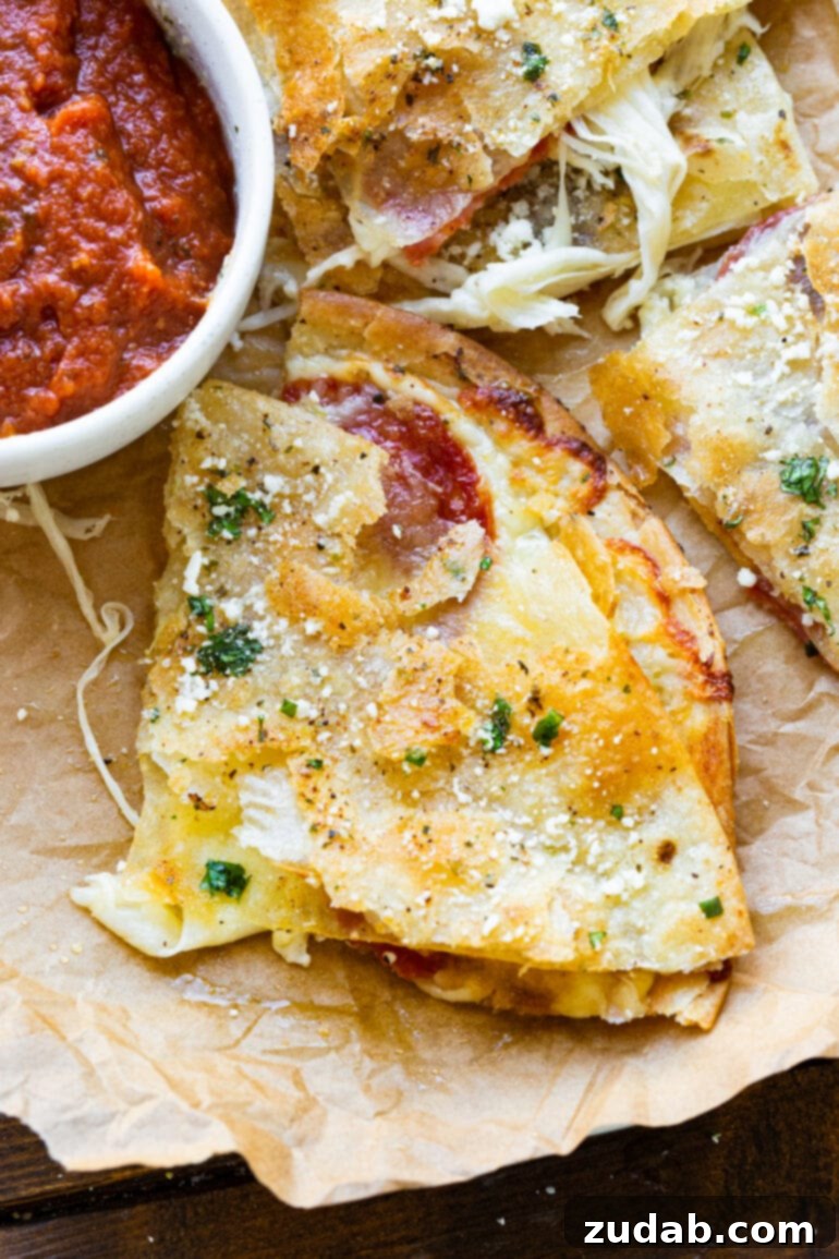 Pizza-dilla: A Cheesy Pizza Quesadilla 2 A golden, crispy slice of tortilla pizza, oozing with melty cheese, garnished with cotija cheese and garlic butter, served alongside a small bowl of rich pizza sauce.