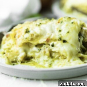 Effortless Creamy Pesto Chicken Lasagna 11 A top-down view of a delicious serving of chicken pesto lasagna, showing off its creamy layers.