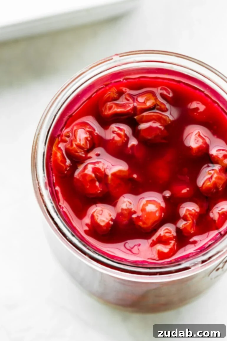 Luscious Homemade Cherry Pie Filling 3 a photo taken over the top of a glass jar full of homemade cherry pie filling
