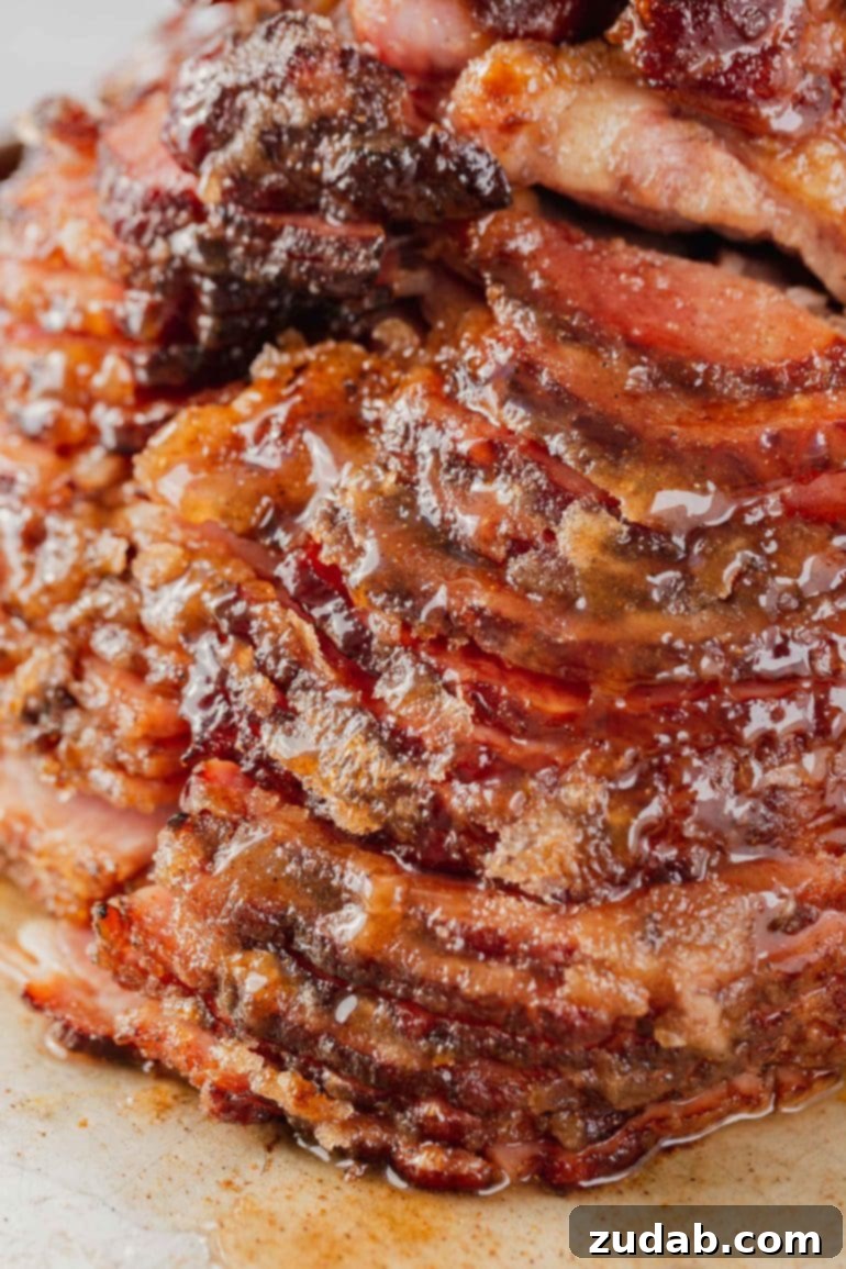 Weekly Meal Plan - Mar. 25 to Mar. 31 9 A tantalizing close-up photograph of a honey-baked spiral-cut ham, glistening with a rich, caramelized glaze. The intricate spiral cuts are visible, showcasing the tender, juicy interior of the ham, while the glossy glaze reflects the light beautifully. This image perfectly captures the inviting and celebratory nature of a holiday ham, highlighting its succulent texture and irresistible appearance.