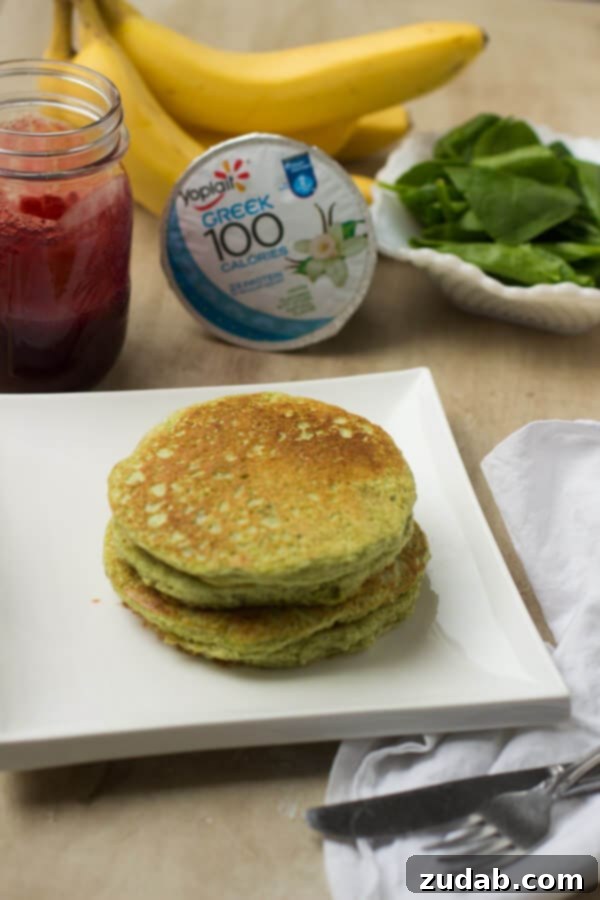 Close-up of fluffy Green Monster Pancakes on a plate, showcasing their vibrant color and delicious texture. Close-up of fluffy Green Monster Pancakes on a plate, showcasing their vibrant color and delicious texture.