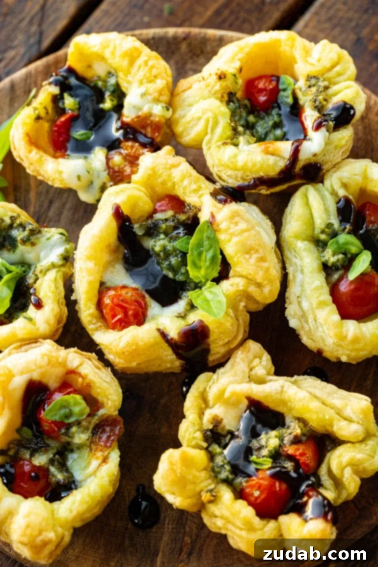Your Ultimate Easter Sunday Feast 8 a photo of several pesto tartlets topped with balsamic glaze, basil and tomatoes