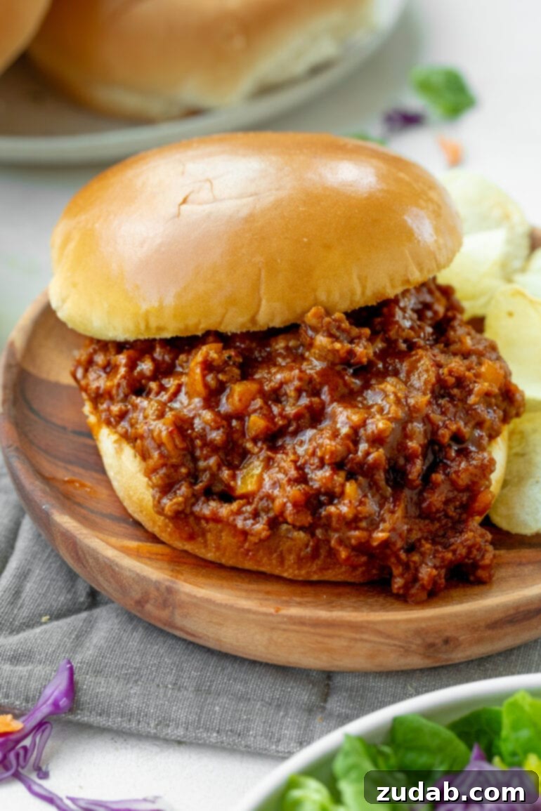 Seven Days of Flavor: April 8-14 7 A sloppy joe sandwich with the meat mixture spilling out, served next to potato chips.