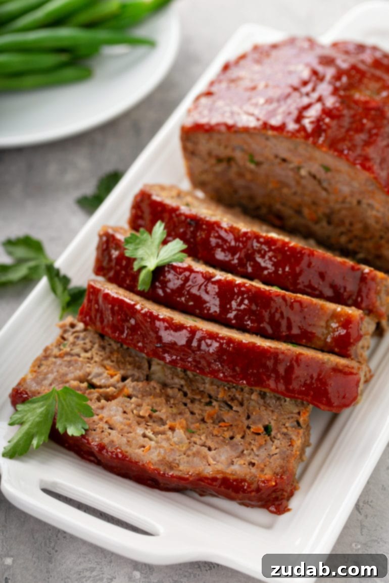 Seven Days of Flavor: April 8-14 9 A tray holding sliced meatloaf sprinkled with parsley, with a side dish of green beans.