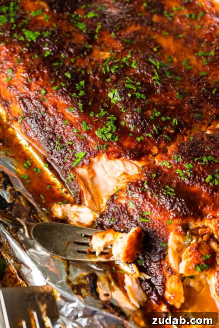 Your Weekly Meal Guide: May 20-26 4 Perfectly cooked Maple Glazed Salmon fillet, glistening with a sweet sauce, served fresh from a foil packet alongside vibrant greens.