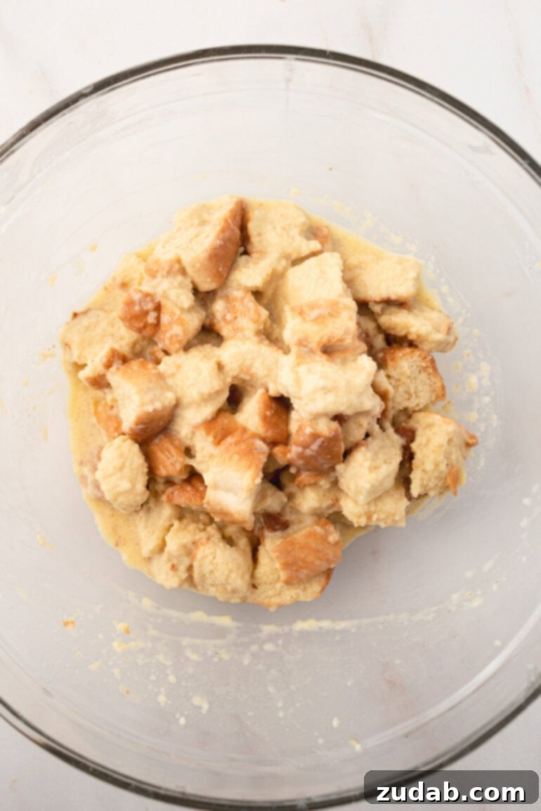 Step-by-step image of coating bread cubes in French Toast Muffin batter