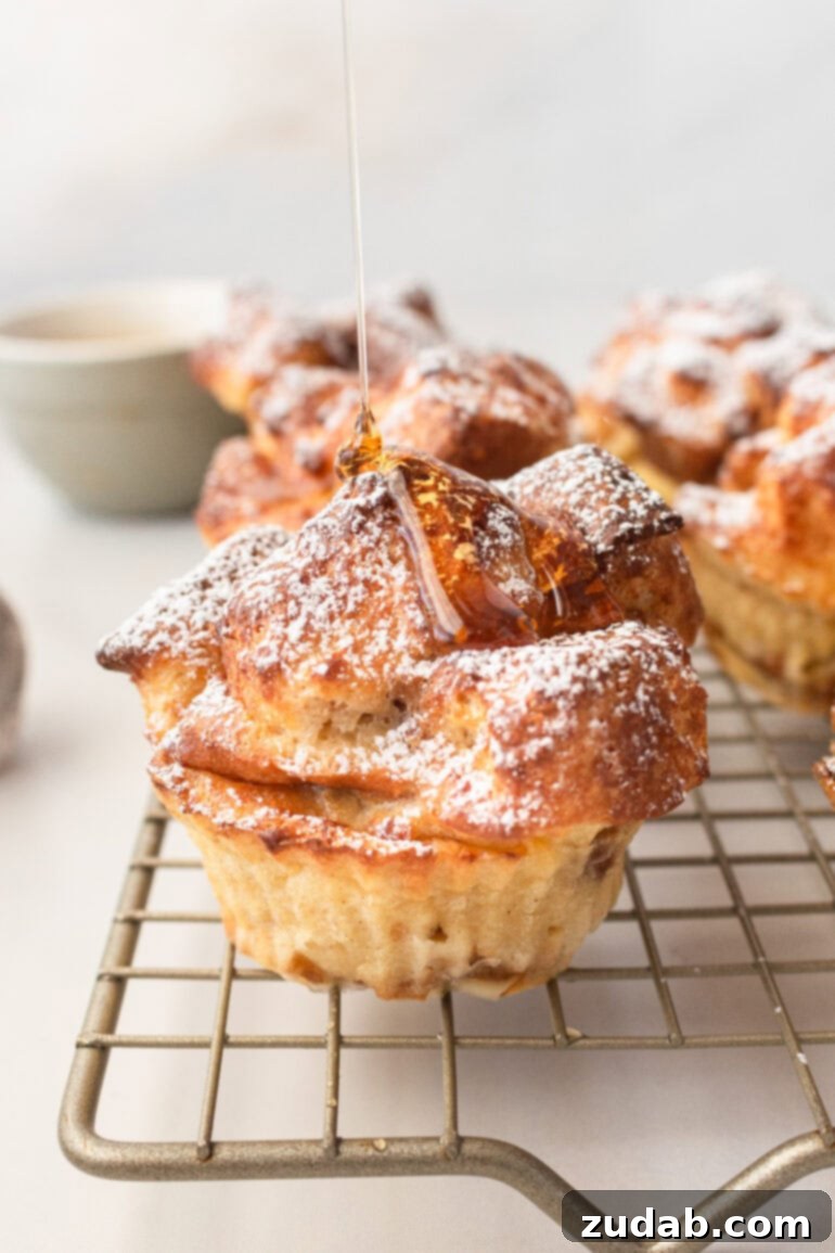 a photo of several golden baked air fryer muffins sitting on a wire cooling rack