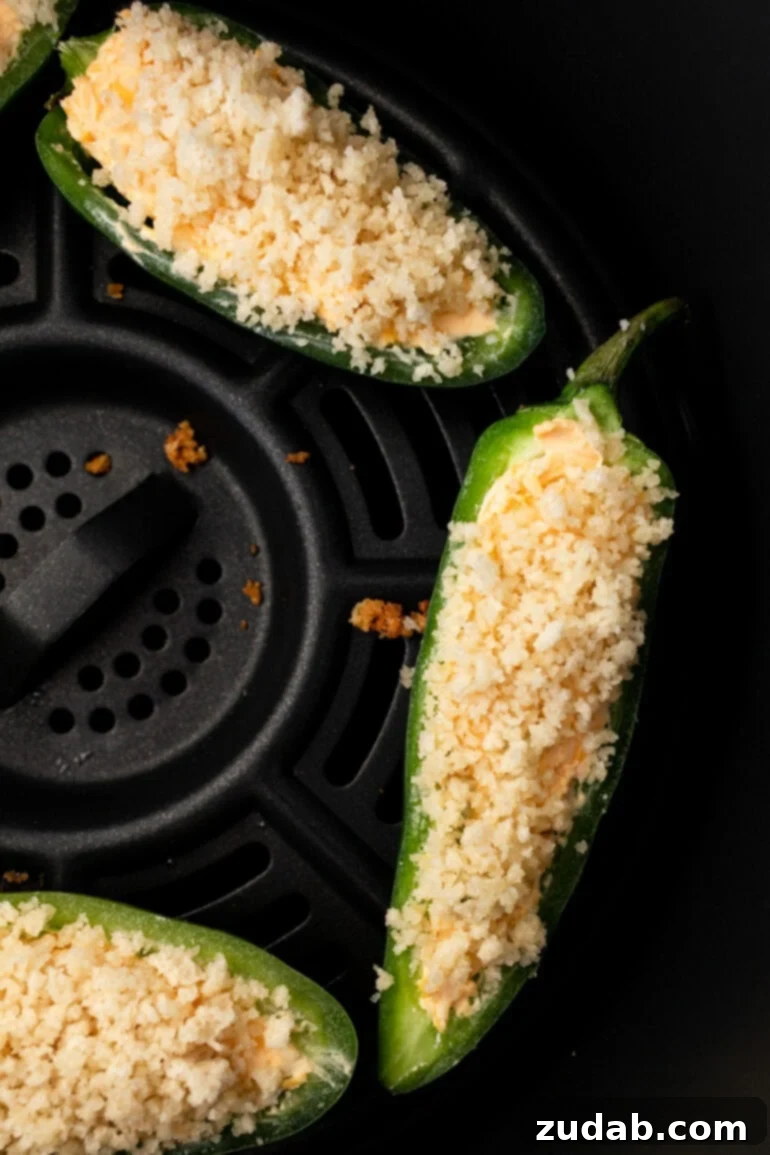 Effortless Air Fryer Jalapeño Poppers 7 A photo gallery of the steps for making jalapeno poppers in the air fryer, showing filled and topped poppers