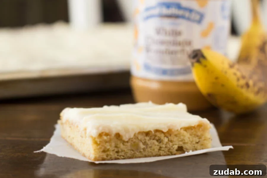 Moist and Flavorful White Chocolate Peanut Butter Banana Cake Close-up of a slice of White Chocolate Peanut Butter Banana Cake with Cream Cheese Frosting