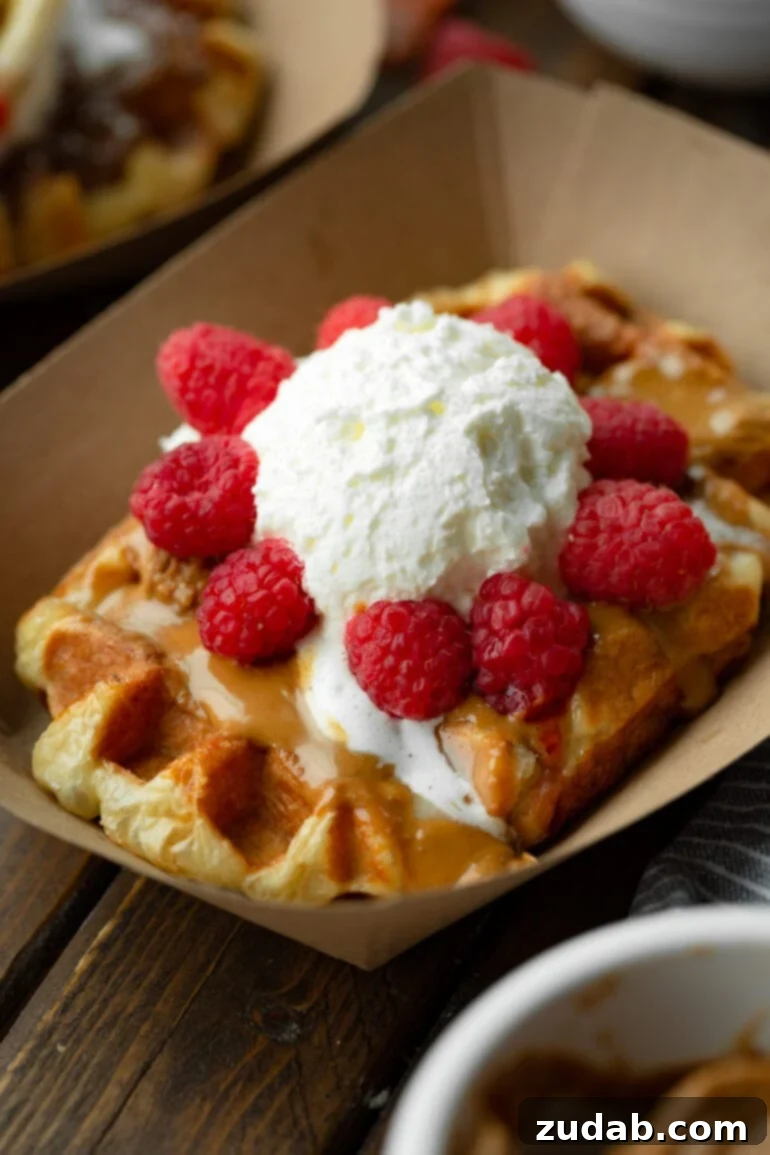 Mastering Waffle Love's Signature Liege Waffles 3 A photo of a large golden Liege waffle topped with melty Biscoff cookie butter, fresh raspberries, and creme fraiche. A delicious Waffle Love inspired treat.