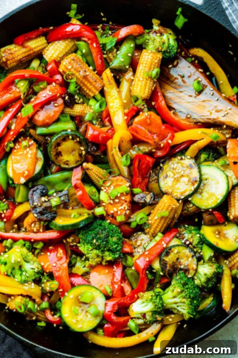 My Go-To Speedy Veggie Stir-Fry 3 A close-up view of fresh, colorful stir fry vegetables including zucchini, broccoli florets, bell peppers, baby corn, and carrots, ready for cooking.
