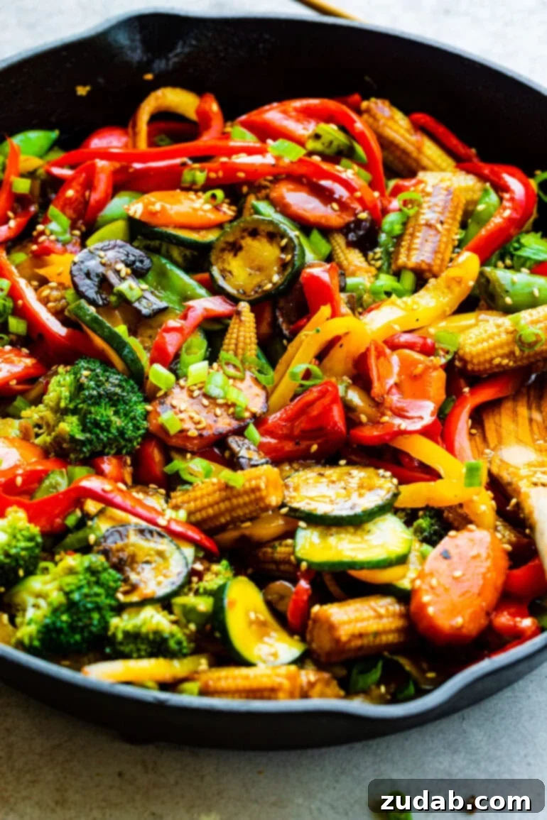 My Go-To Speedy Veggie Stir-Fry 4 A large cast iron skillet brimming with freshly sautéed, colorful vegetables coated in a light, glossy stir fry sauce.