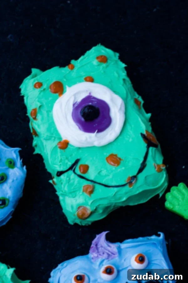Decorating Monster Cookies: A Fun Halloween Activity for Kids Close-up of a child's hands carefully decorating a Halloween monster cookie with colorful frosting and candy eyes