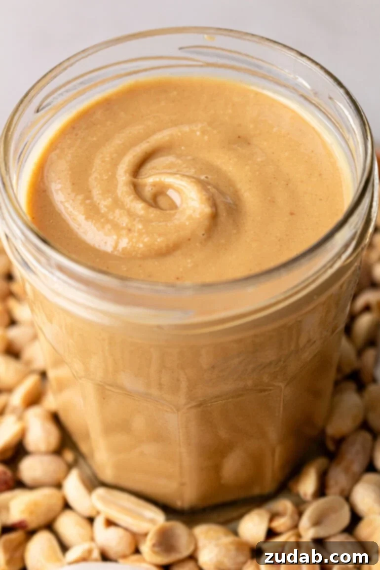 Creamy Coconut Peanut Bliss 2 A photo of a glass jar full of creamy coconut peanut butter, invitingly smooth and rich.