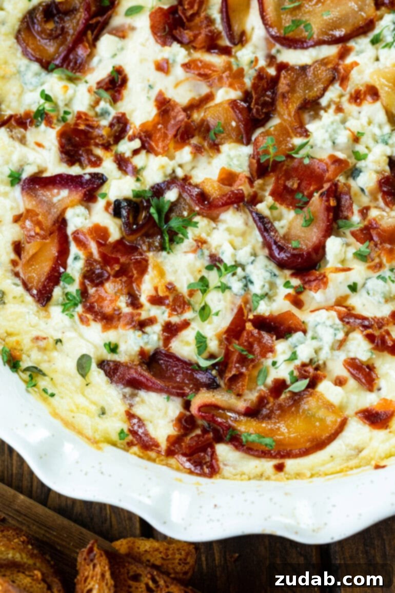 Sweet Pear, Savory Prosciutto & Tangy Blue Cheese Dip 6 A baking dish filled with baked roasted pear and blue cheese dip, garnished with fresh herbs and crispy prosciutto.