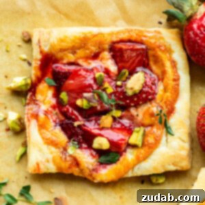 a photo of a roasted strawberry tart sitting next to a container of treasure cave mild blue cheese