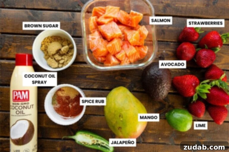 Golden Crispy 7-Minute Air Fryer Salmon Bites with Zesty Mango Salsa 4 An overhead shot displaying all the fresh ingredients for air fryer salmon bites and strawberry mango avocado salsa, neatly arranged in individual small bowls, ready for preparation.