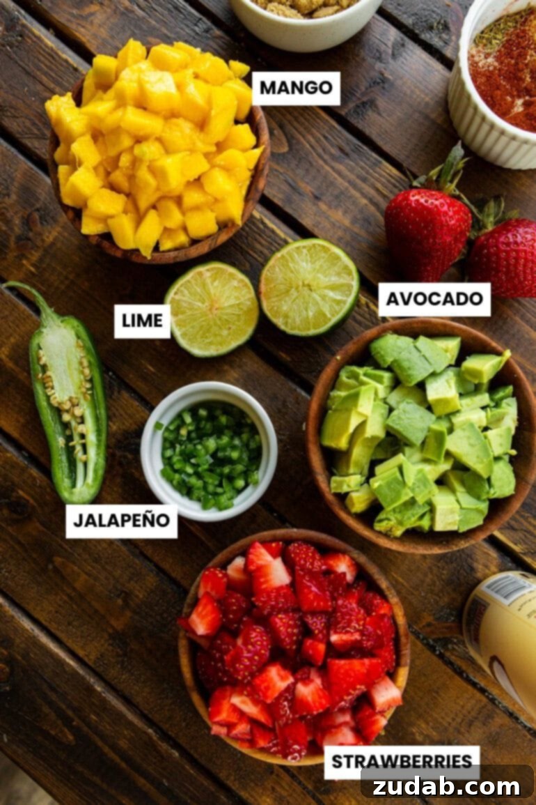 Golden Crispy 7-Minute Air Fryer Salmon Bites with Zesty Mango Salsa 5 An aesthetically pleasing flat lay photograph showcasing all the individual ingredients required for the fresh strawberry mango avocado salsa, each neatly portioned in separate small bowls and clearly labeled.