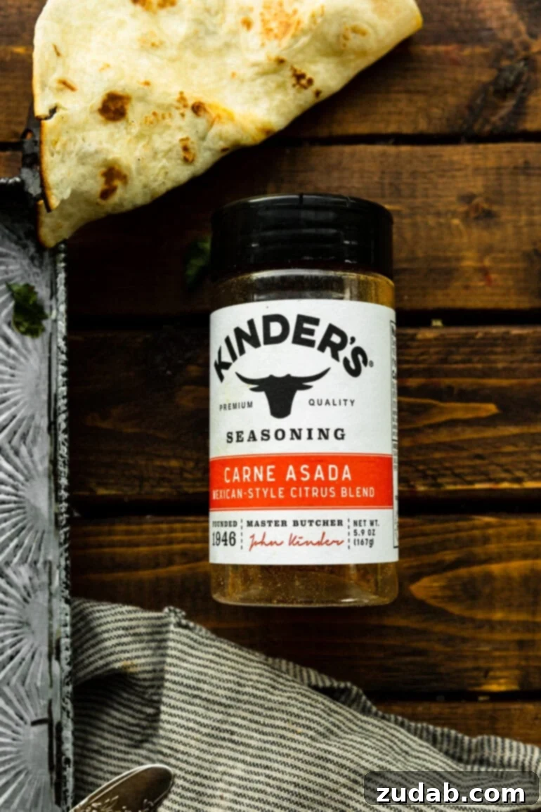 Deliciously Easy 5-Ingredient Shredded Beef Tacos 3 A close-up shot of a bottle of Kinder's Carne Asada Rub, showcasing its vibrant label and promising rich flavors for your next meal.