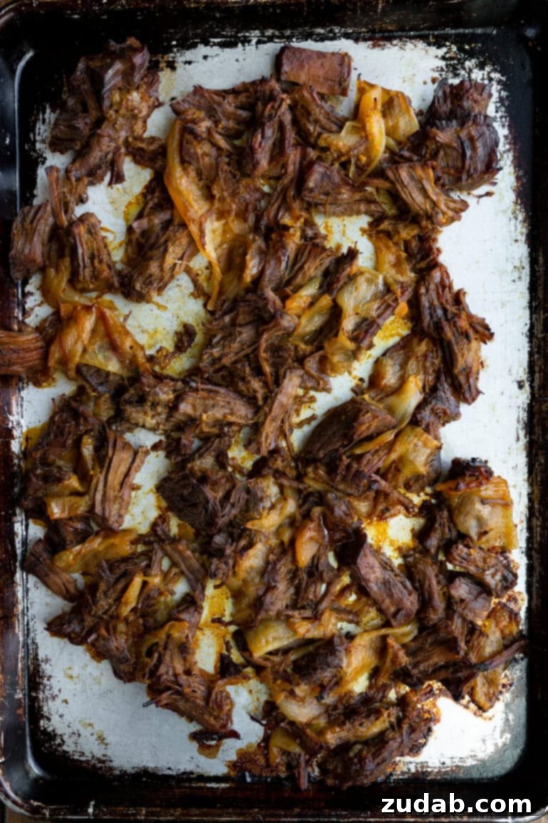 Deliciously Easy 5-Ingredient Shredded Beef Tacos 7 Shredded beef mixed with caramelized onions, creating a rich and aromatic filling.