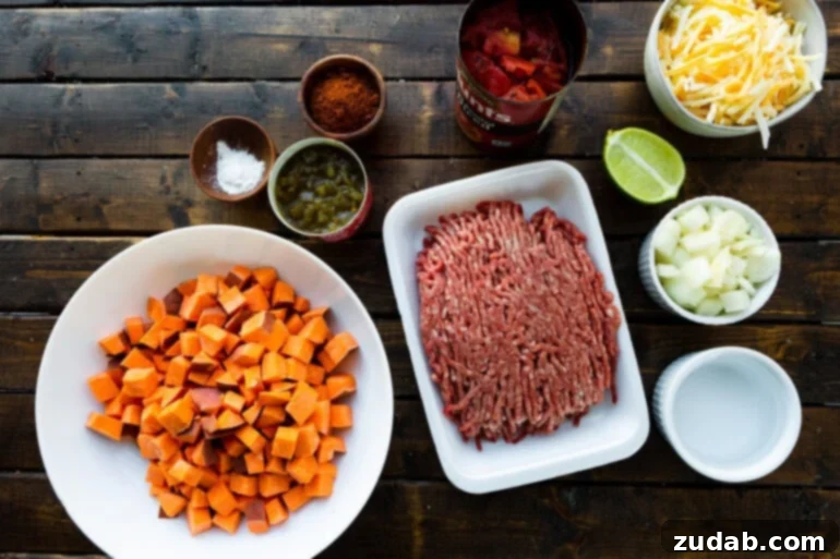 Taco Beef and Sweet Potato Skillet 3 A flat lay photograph showcasing all the fresh and canned ingredients neatly arranged for the ground beef and sweet potato skillet meal. This image highlights the wholesome components that come together to create a quick and healthy taco-inspired dish, perfect for one-pan cooking.