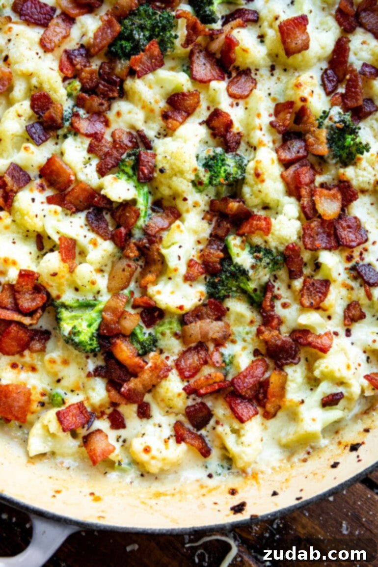 Creamy Garlic Parmesan Broccoli Cauliflower with Crispy Bacon 6 A beautiful family-style photo of the creamy garlic parmesan broccoli and cauliflower dish in a baking dish, brimming with vegetables, melted cheese, and crisp bacon, ready to be served at a gathering.