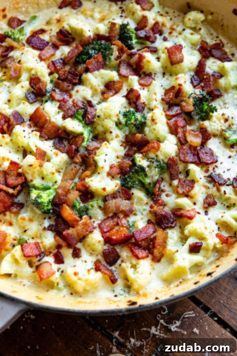 Creamy Garlic Parmesan Broccoli Cauliflower with Crispy Bacon 10 A close-up shot of a serving of creamy broccoli and cauliflower, showing the rich texture of the sauce, tender vegetables, and inviting crispy bacon bits, ready to be enjoyed.