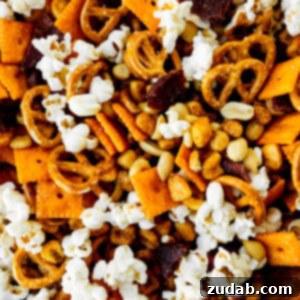 Super Bowl's Ultimate Manly Snack Attack 6 A photo taken over the top of a snack mix loaded with popcorn, pretzels, Cheez-Its, peanuts, and beef jerky, ready to be served at a Super Bowl party.