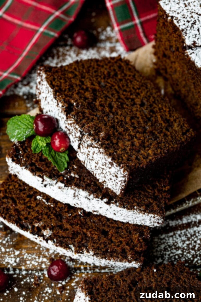 Warm Spiced Gingerbread Loaf 2 Several slices of moist gingerbread loaf layered, garnished with whole cranberries and evergreen sprigs.