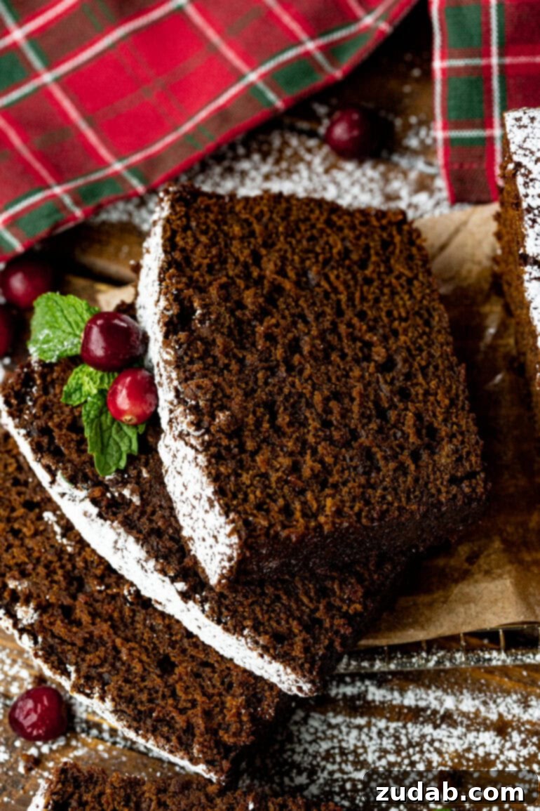 Warm Spiced Gingerbread Loaf 13 A stack of gingerbread slices lightly dusted with powdered sugar.