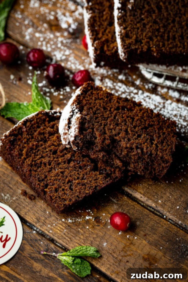 Warm Spiced Gingerbread Loaf 9 Two thick slices of moist gingerbread loaf stacked on a table.