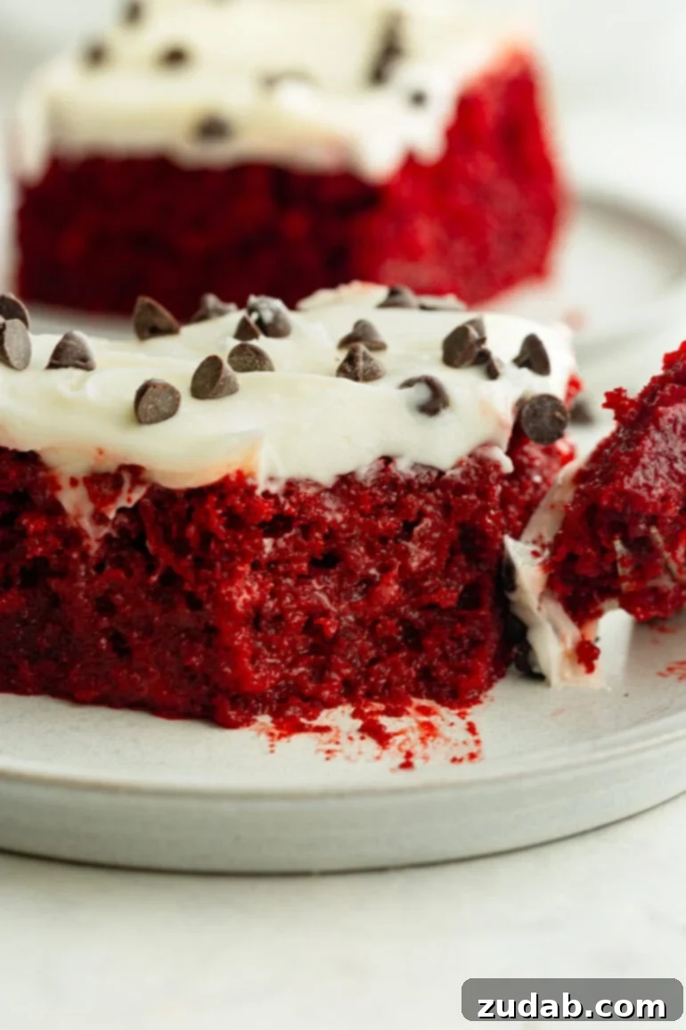 The Ultimate Red Velvet Poke Cake: Foolproof & Delicious 7 Moist Red Velvet Poke Cake with a Bite Removed
