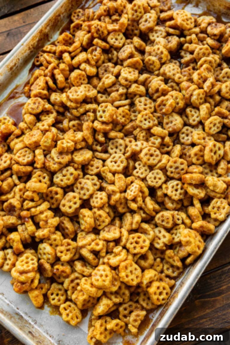 Easy No-Bake Churro Crunch 9 a photo of a sheet pan filled with caramel coated honeycomb cereal covered in cinnamon sugar