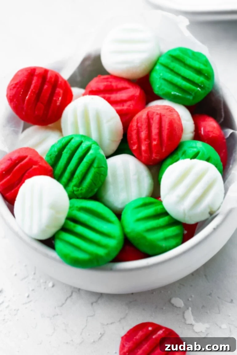 Classic Cream Cheese Mints: A Nostalgic Treat 5 A bowl of homemade cream cheese mints in red, white, and green
