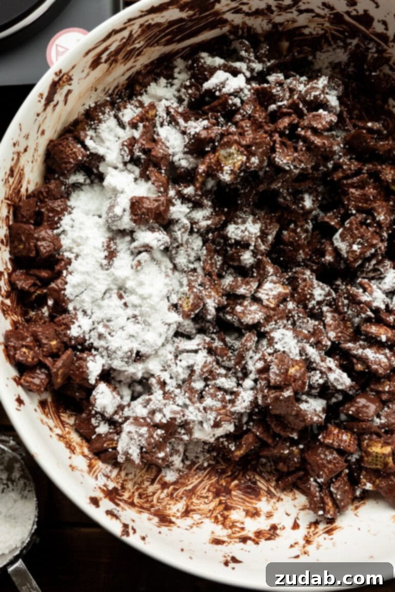 Decadent Dark Chocolate Peanut Butter Muddy Buddies 7 Stirring Chex cereal to coat evenly with the dark chocolate peanut butter mixture.