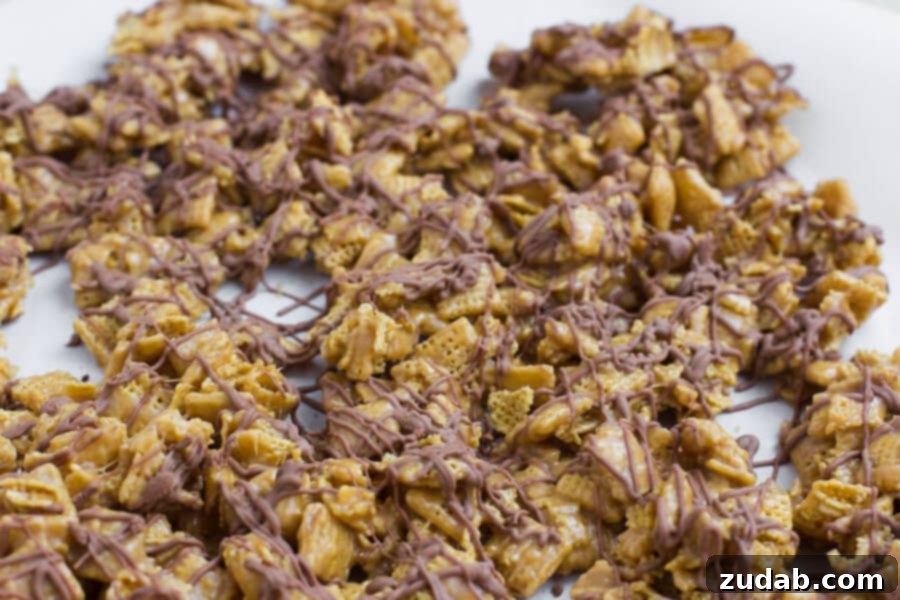 Scotcheroos Chex Mix cooling on parchment paper