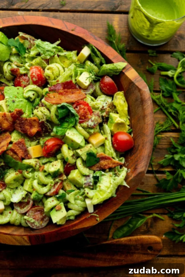 BLT Pasta Perfection 8 A large wooden serving bowl filled with a generous portion of creamy BLT pasta salad, ready to be served.