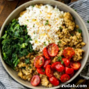 7 Minute High Protein Savory Cottage Cheese Oats 11 a photo of a bowl of crispy golden oats, cottage cheese, tomatoes and kale topped with seasonings