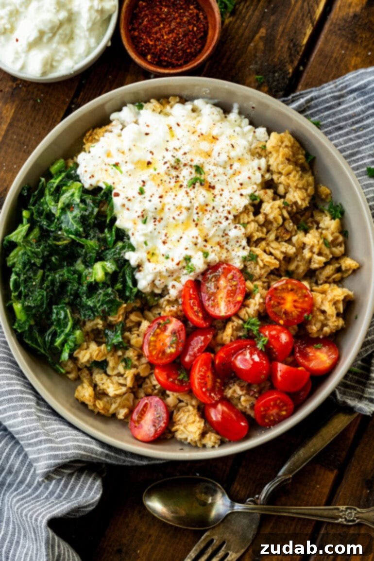 7 Minute High Protein Savory Cottage Cheese Oats 10 a photo of a bowl of crispy golden oats, cottage cheese, tomatoes and kale topped with seasonings
