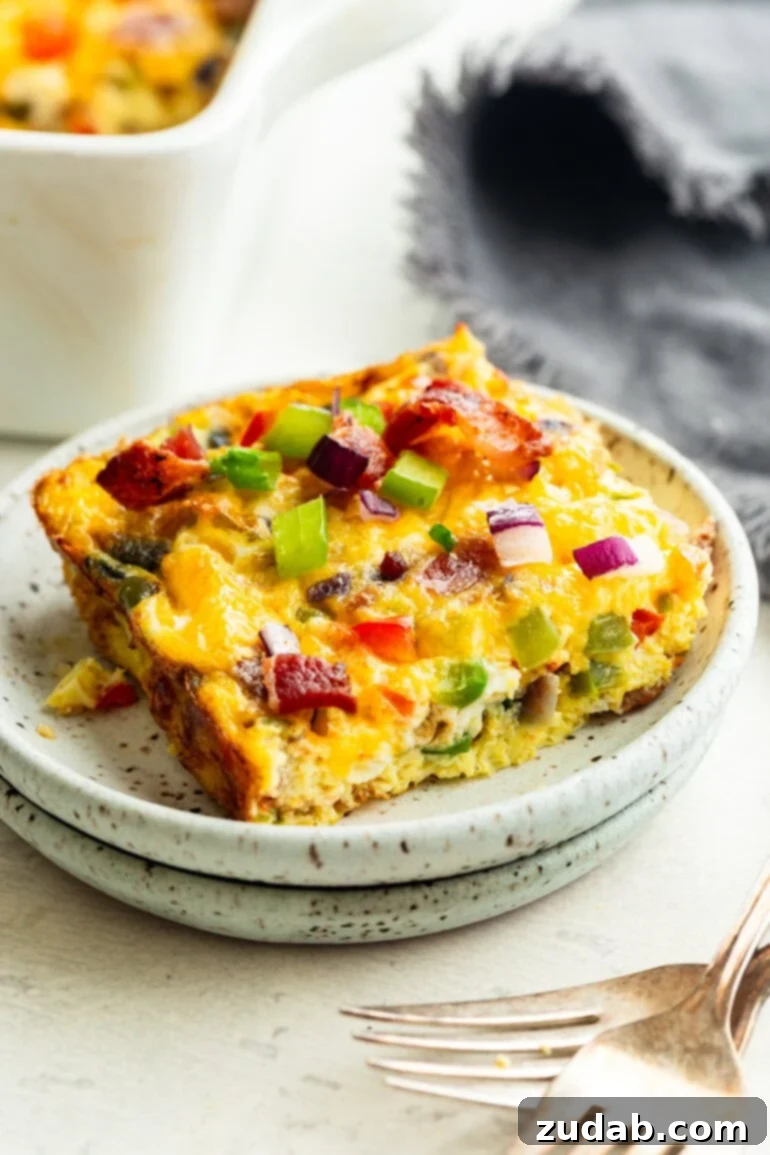 Cheesy Bacon Breakfast Bake 4 Serving of Cheesy Bacon Baked Egg Casserole on a Plate