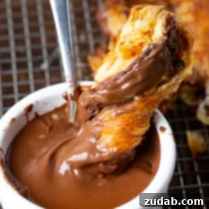 A festive Nutella and Dulce de Leche Puff Pastry Christmas Tree, golden and ready to serve.
