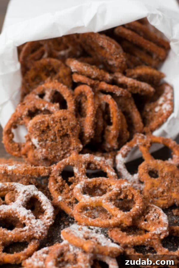 Easy Snack Recipe: Churro Pretzels for Any Occasion Pile of crispy Churro Pretzels on a white plate, ready to eat