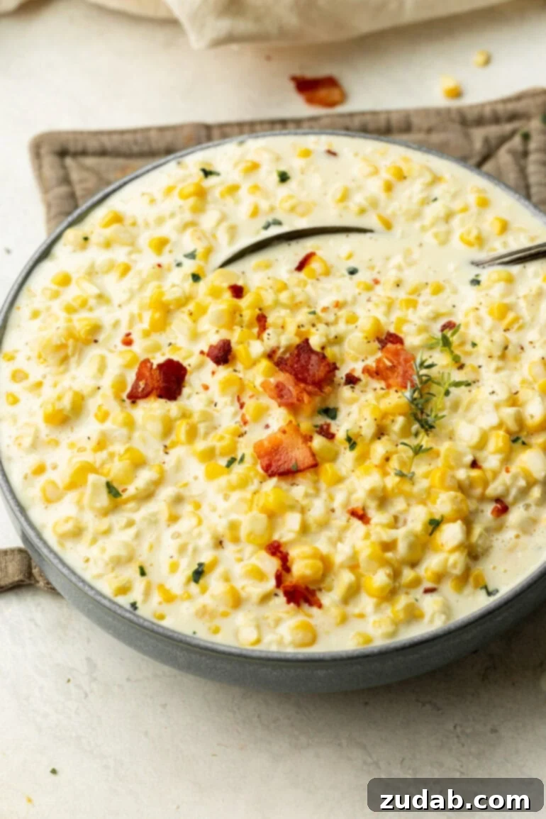 The Best Creamed Corn Recipe Ever Golden, rich creamed corn in an large bowl, finished with crispy bacon and fresh chopped herbs.