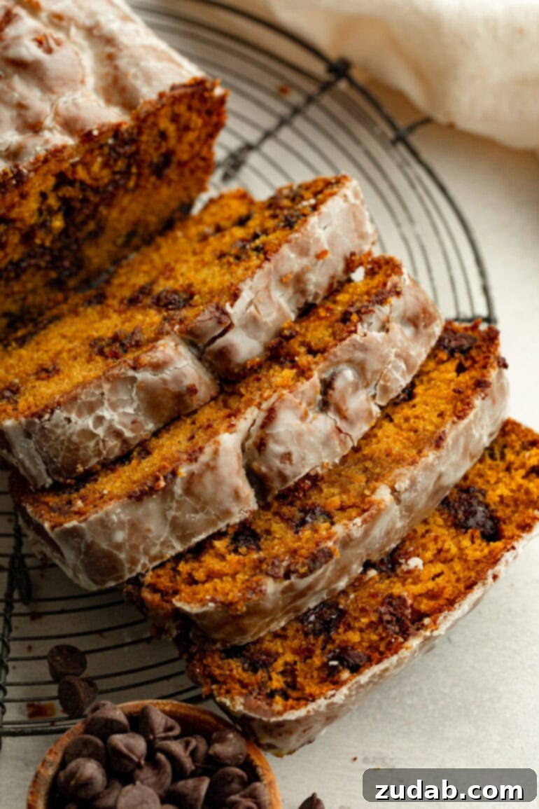 Heavenly Pumpkin Chocolate Chip Loaf 2 A beautifully sliced loaf of glazed pumpkin chocolate chip bread, showcasing its moist texture and melty chocolate chips.